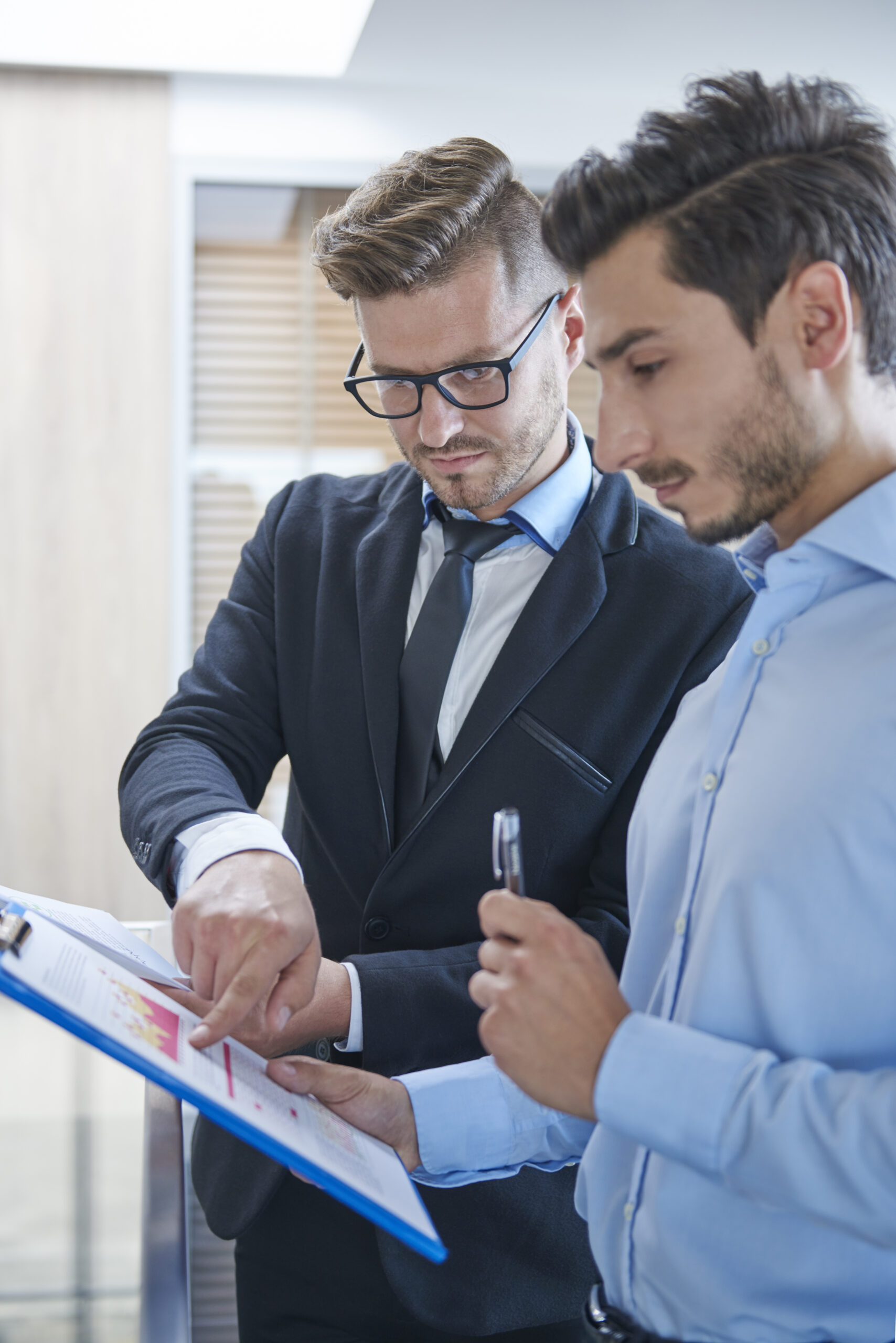 two men analyzing some documents