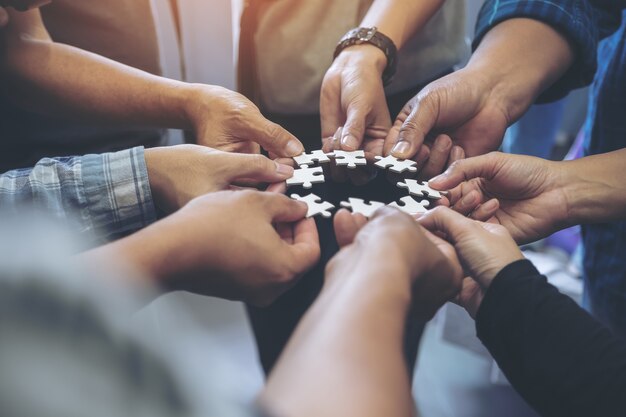 [freepicdownloader.com] people hands holding jigsaw puzzle circle together normal