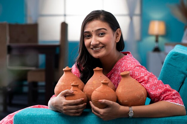 [freepicdownloader.com] woman adult holding mud piggy banks her hand normal